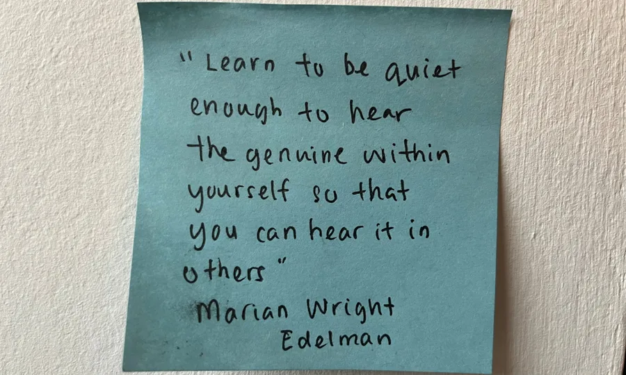A handwritten sticky note quoting Marian Wright Edelman: Learn to be quiet enough to hear the genuine within yourself so that you can hear it in others